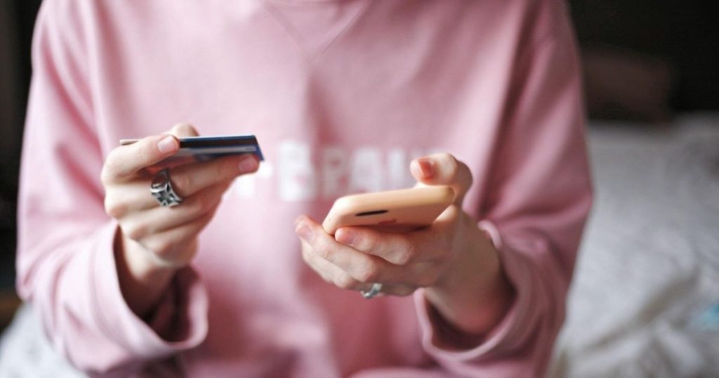 A woman online shopping on a mobile phone.